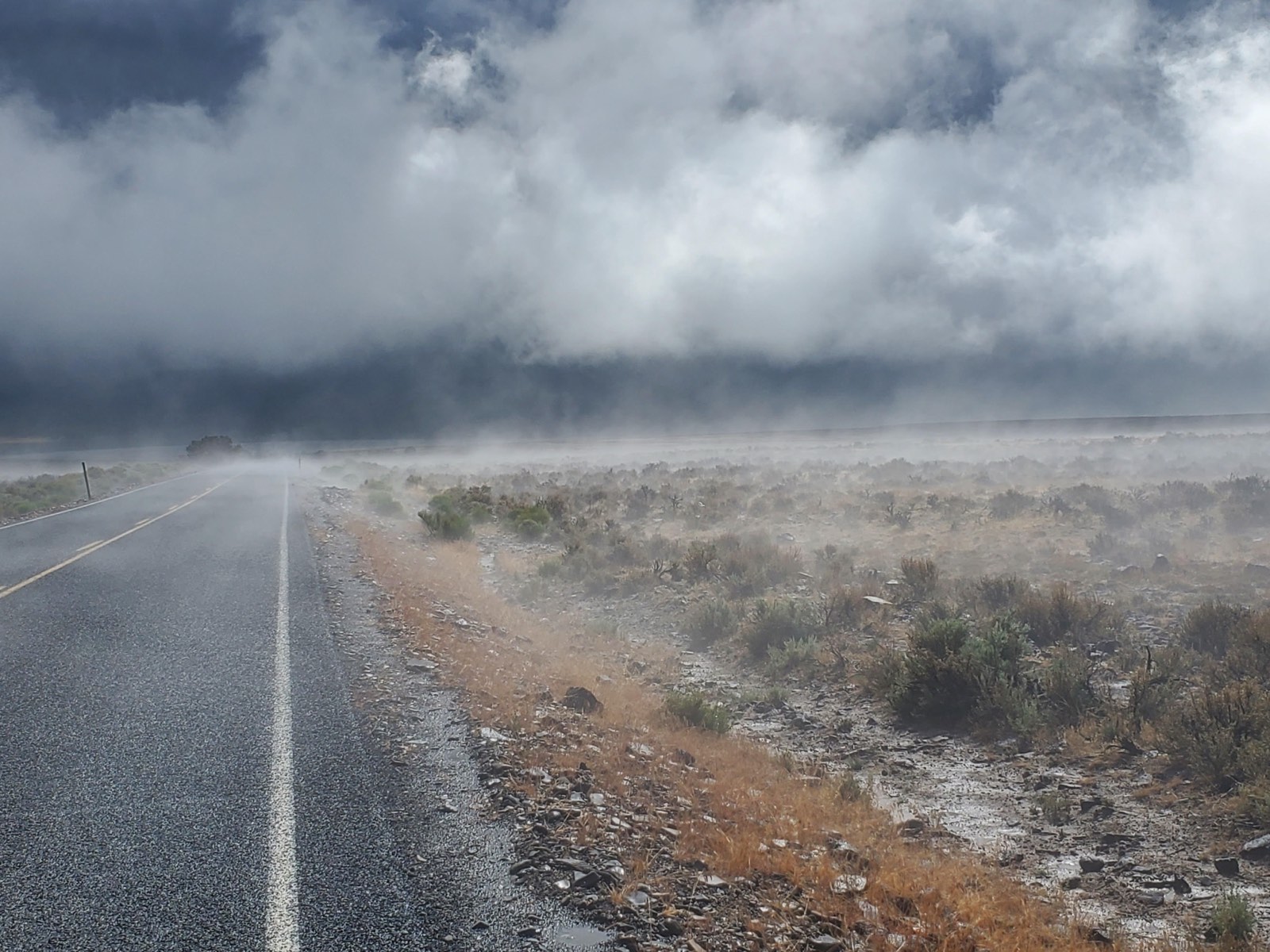 Dramatic clouds building over a high desert road, photo by Michael Fitzsimmons
